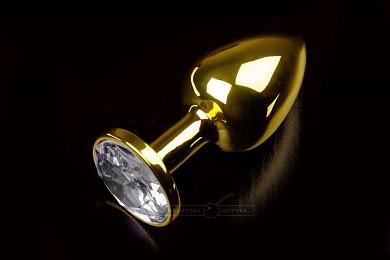 Маленькая золотистая анальная пробка с прозрачным кристаллом - 7,5 см.