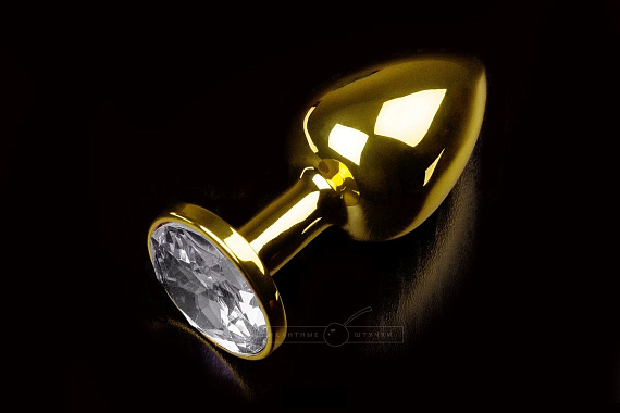 Маленькая золотистая анальная пробка с круглым кончиком и прозрачным кристаллом - 7 см.