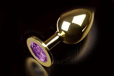 Большая золотистая анальная пробка с фиолетовым кристаллом - 9 см.